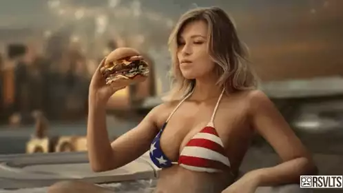 Woman in American Flag Bikini Enjoys a Burger