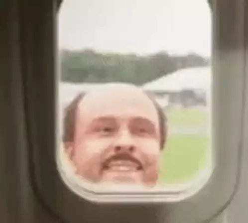 Man Smiling from Plane Window