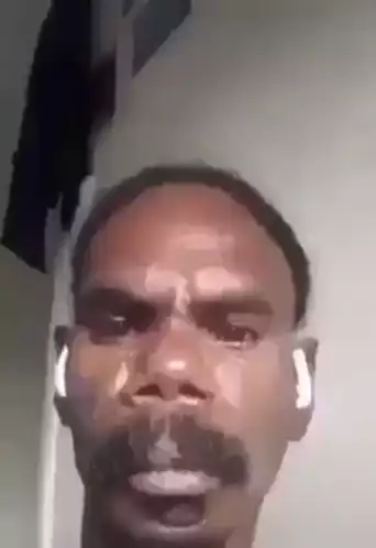 Man with Earbuds Making Funny Face