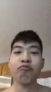 Asian Man Making Funny Face While Eating
