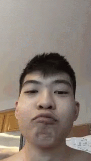 Asian Man Making Funny Face While Eating