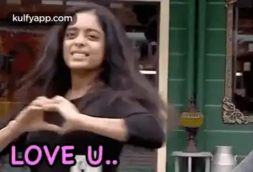 Woman Shows Love U with Heart Hands